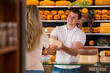 © Milles Studio - Male salesman in cheese store with a female customer