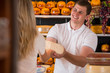 © Milles Studio - Male salesman in cheese store with a female customer