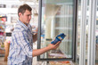 © Milles Studio - Man in a supermarket standing in front of the freezer