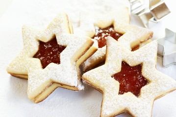 Christmas cookies and cookie cutters on white background.