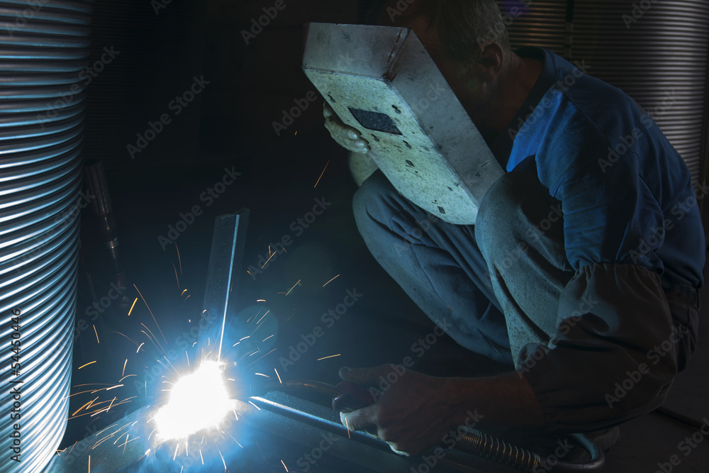 Sparks coming out of welding torch - obrazy, fototapety, plakaty 