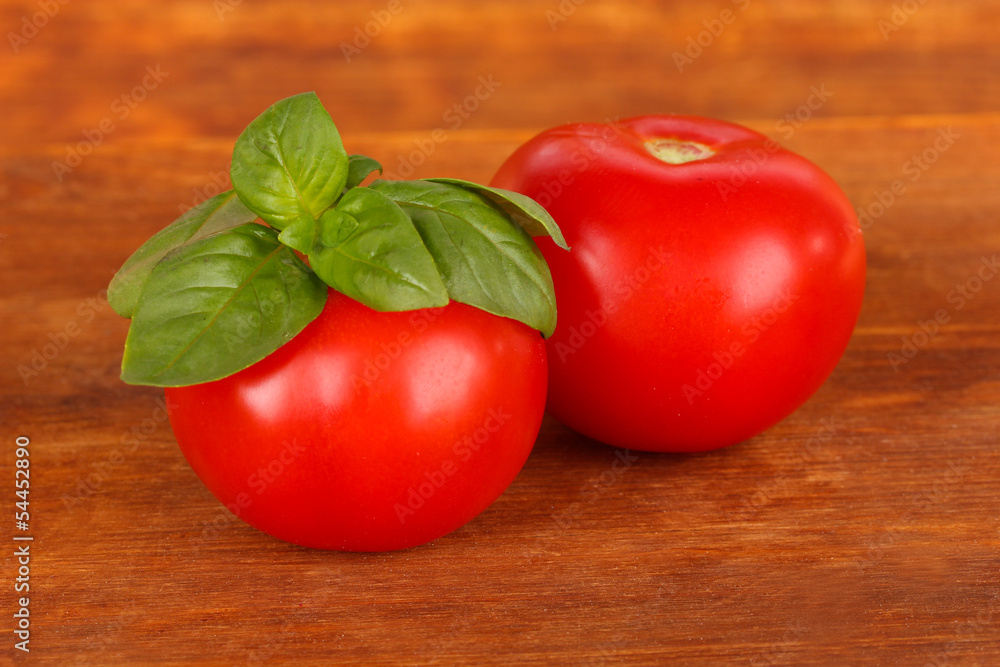 Tomato and basil on wooden background