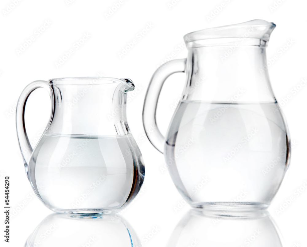 Glass pitchers of water isolated on white