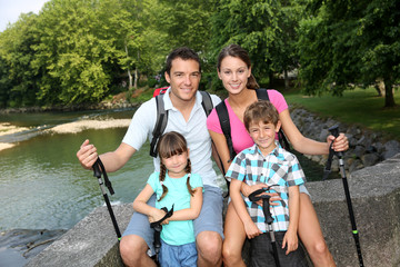 Wall Mural - Happy family relaxing on a bridge