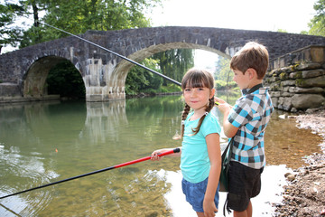 Wall Mural - Kids enjoying fishing time in beautiful river