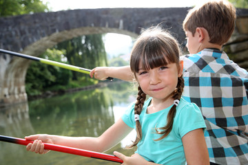 Wall Mural - Kids enjoying fishing time in beautiful river