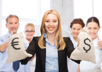 Canvas Print - businesswoman holding money bags with dollars