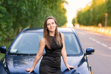 Wall Mural - Beautiful businesswoman near her car