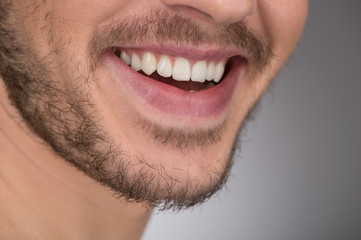 Wall Mural - Happy smile. Cropped image of young men smiling while standing i