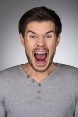 Wall Mural - Angry men. Portrait of young men shouting and looking at camera