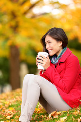 Wall Mural - Autumn woman drinking coffee in fall forest