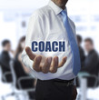 © WavebreakmediaMicro - Elegant businessman holding the word coach