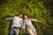 Couple In Love Lying On Grass