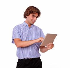 Wall Mural - Handsome young man working on his tablet pc