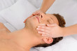 © BlueSkyImages - Facial massage. Top view of relaxed young men lying on the massa