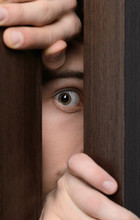 Men Peeking. Close-up Of Men Peeking Through The Open Door