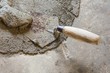 hand using trowel  with wet concrete floor