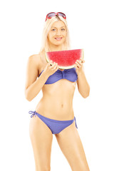 Sticker - Young attractive woman in bikini holding a slice of watermelon