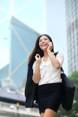 Wall Mural - Business woman talking on phone outdoor, Hong Kong