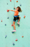 Fototapeta  - smiling child climbing up the wall