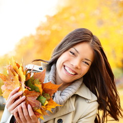 Wall Mural - Autumn / Fall woman holding colorful leaves