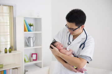 Wall Mural - asian male doctor and newborn baby on the clinic