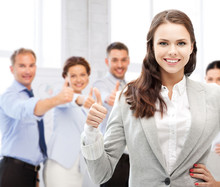 Businesswoman Showing Thumbs Up In Office