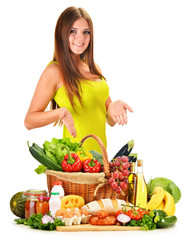 Fototapete - Young woman with assorted grocery products isolated on white