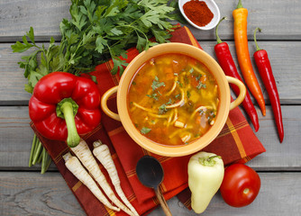 Wall Mural - Top view on pot of tomato soup and fresh vegetables on old woode