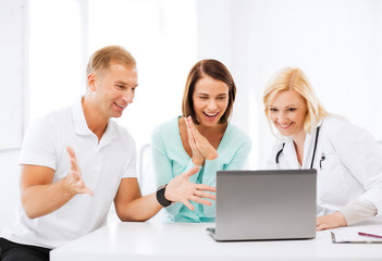 Sticker - doctor with patients looking at laptop