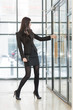 © Pavel Losevsky - Business woman pulling the glass door handle