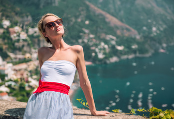 Wall Mural - Beautiful young woman and view of Positano, Italy