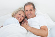 © Andrey Popov - Happy Senior Couple On Sleeping Bed