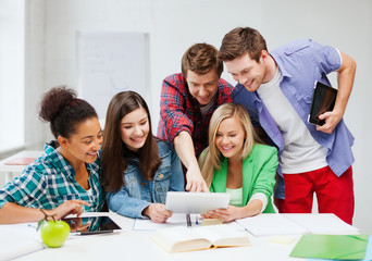Wall Mural - students looking at tablet pc at school