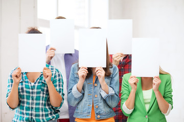 Wall Mural - students covering faces with blank papers