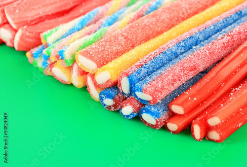 Fototapeta na wymiar Sweet jelly candies on green background.