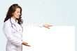 © adam121 - young woman doctor with a blank banner