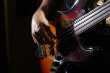 Man Playing An Bass Guitar With Brown Body