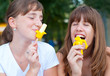Two cute happy teenage girls eating ice cream