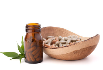 Wall Mural - Herbal drug capsules in brown glass bottle. Alternative medicine