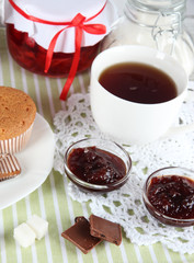 Yummy jam in bank on napkin on wooden table