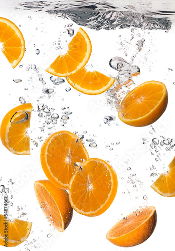 Fototapeta na wymiar Healthy Water with Fresh Oranges. Drops