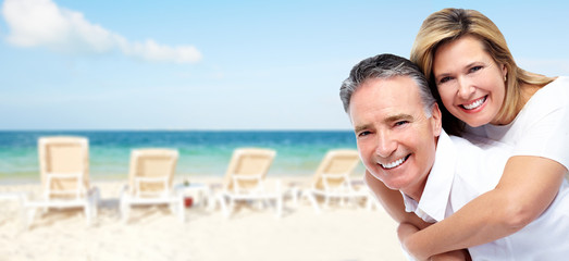 Happy senior couple on a tropical beach.