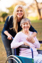 Sticker - senior woman in a wheelchair and her daugther