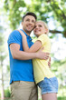 © BlueSkyImages - Loving couple in park. Low angle view of young loving couple hug
