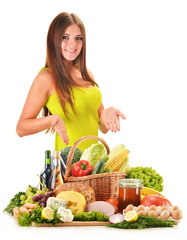 Fototapete - Young woman with assorted grocery products isolated on white