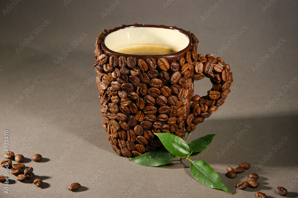 Cup of coffee beans, on grey background