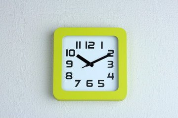 Office clock on color wall background