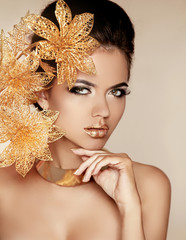 Wall Mural - Beautiful Girl With Golden Flowers. Beauty Model Woman Face. Per