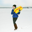 Woman running with package in the winter landscape